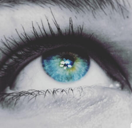 A creepy but pretty nice blue eye with some yellow toward the pupil. All but iris is black and white because the OP is dramatic.